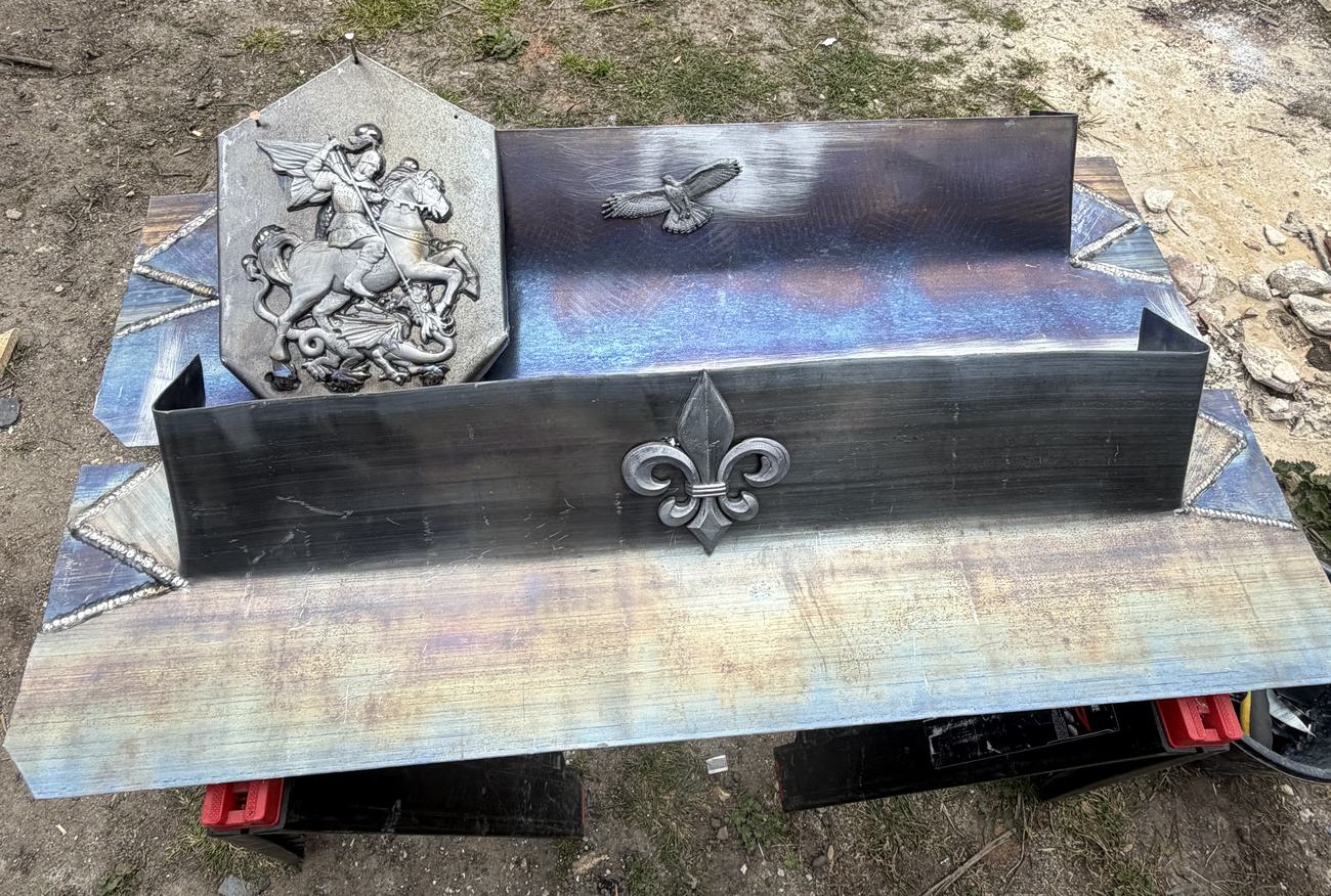 Bespoke leadwork by CHM Roofing with St George and dragon panel and fleur-de-lis detail